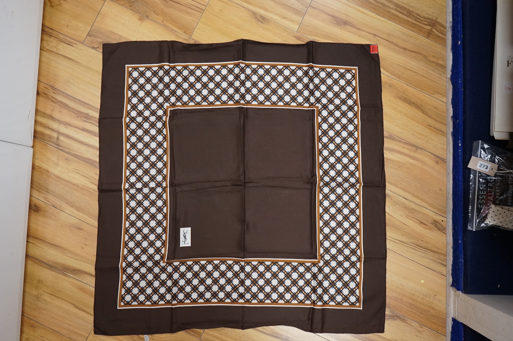 Two Yves Saint Laurent silk scarves comprising a monogrammed example and a patterned brown example with Foulards folding case